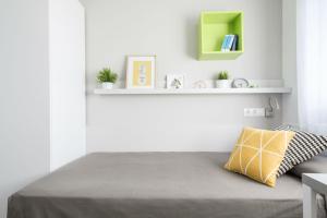 a bedroom with a bed with a green shelf at Residencia Universitaria Barcelona Diagonal in Barcelona