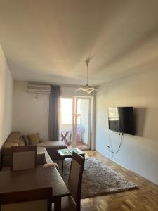 a living room with a couch and a table at Apartment Tramonto Budva in Budva