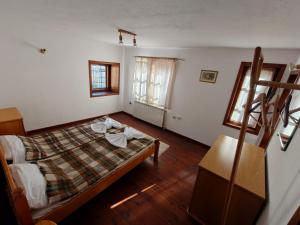 a bedroom with a bed and a table in it at White Wolf Chalet in Bansko