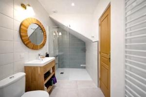 a bathroom with a sink and a toilet and a mirror at Ferme du Grand Breton - Chambres et Table d'hôtes in Beaumont-de-Lomagne +26 photos