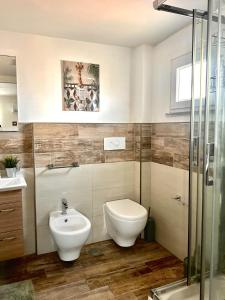a bathroom with a toilet and a sink at The Attic in Civitavecchia