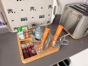 a tray with utensils on a counter next to a mixer at Four Paws Glamping in Aberystwyth