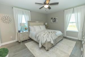 a bedroom with a bed and a ceiling fan at Lake Marlin Villa 2 in Port Charlotte