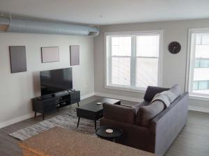 a living room with a couch and a tv at Historic 2BR stay with patio & elevator in Indianapolis