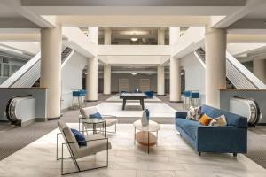 a lobby with couches and chairs and a table at Historic 2BR stay with patio & elevator in Indianapolis