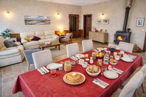 a living room with a table with food on it at Ferme du Grand Breton - Chambres et Table d'hôtes in Beaumont-de-Lomagne