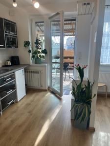 a kitchen with a refrigerator and a table at Studio pod Orzechem in Zbąszyń +13 photos