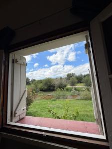 an open window with a view of a field at Habitación con baño privado con cocina separada in Villa Cura Brochero