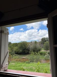 a window view of a field from a house at Habitación con baño privado con cocina separada in Villa Cura Brochero +2 photos