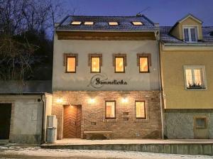 a building with a sign on the side of it at Sommeliérka - ubytování & vinný sklep in Valtice