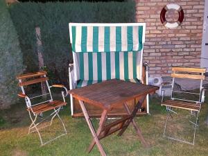 a chair and a table and two chairs in a yard at Windrose in Korswandt