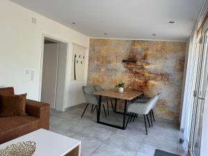 a living room with a table and chairs at Windrose in Korswandt +7 photos