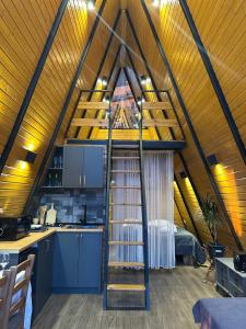 a room with a spiral staircase in a attic at Orange Cottage in Agara