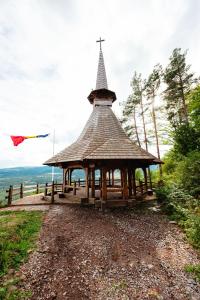 a gazebo with a cross on top of it at Vila TeoNa in Topliţa
