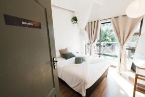 a bedroom with a bed and a large window at Entire house perfect for group trips and families in Cape Town in Cape Town +34 photos