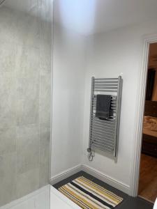 a bathroom with a shower with a towel rack at Dune Delight in Camber +22 photos