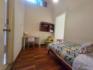 a bedroom with a bed and a table and a chair at Santa Marta Casona in Arequipa