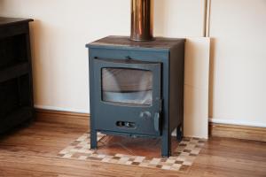 a blue stove sitting on a floor in a room at Entire house perfect for group trips and families in Cape Town in Cape Town