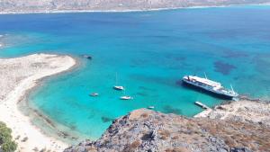 an aerial view of a beach with boats in the water at Elafonisos Rooms in Kefálion +11 photos