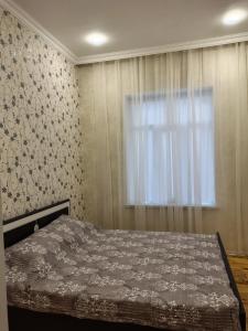 a bedroom with a bed and a window at Riverside villa in Qusar