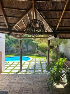 a pergola with a view of a swimming pool at Entire house perfect for group trips and families in Cape Town in Cape Town