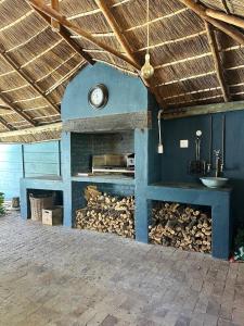 a fireplace with a clock on top of it at Entire house perfect for group trips and families in Cape Town in Cape Town