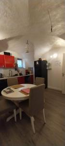 a kitchen with a table and chairs in a room at A L ESCALE PASSA PAÏS in Le Poujol-sur-Orb