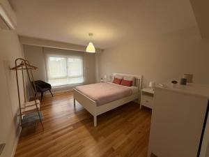 a bedroom with a bed and a desk and a window at Casa Pilar segundo in Sigüeiro