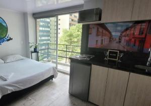 a bedroom with a bed and a flat screen tv at Las Aguas Inner Experience in Bogotá