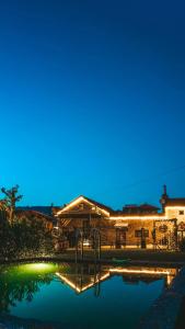 a house with a swimming pool at night at Quinta da Eira do Prado in Carvalho +21 photos