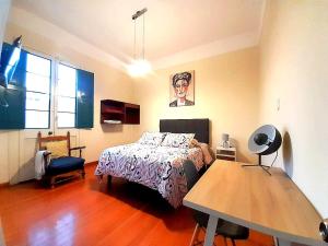 a bedroom with a bed and a table in it at Santa Marta Casona in Arequipa