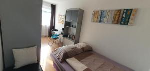 a small bedroom with a bed and a desk at Sleep&Coffee&Go in Trier