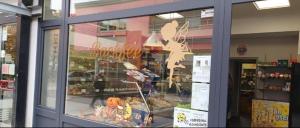 a store front window of a bakery with a display at Sleep&Coffee&Go in Trier +15 photos