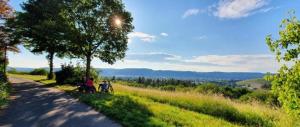 two people sitting on the side of a road at Sleep&Coffee&Go in Trier