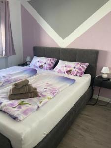 a bedroom with two beds with pink and purple pillows at Seehaas1 in Friedrichshafen
