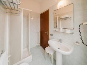a white bathroom with a sink and a mirror at Hotel Umbria Orvieto-Nuova Gestione- in Orvieto +44 photos
