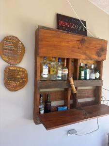 a wooden spice shelf on a wall with medicines at B&B Le Villette Las Lajas in Las Lajas