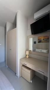 a white room with a desk with a large mirror at Thealos in Azolimnos Syros +39 photos