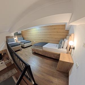 a bedroom with a large bed and a couch at Salillari Guest house & Restaurant in Berat