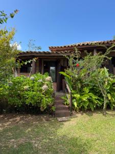 a house with a stairway leading to the front yard at Encanto do Mar Praia do Rosa in Praia do Rosa