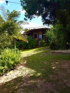 a house with a yard in front of it at Encanto do Mar Praia do Rosa in Praia do Rosa