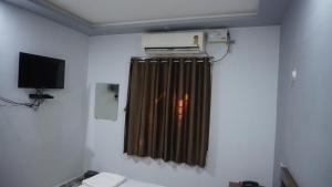 a room with a heater and a television on the wall at Hotel Akshada & Guest House in Banda