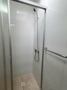 a shower with a glass door in a bathroom at Nido Del Bosque in Pucón +102 photos
