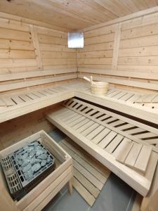 a wooden sauna with two beds and a basket at Apartment Elli in Lichtenhain
