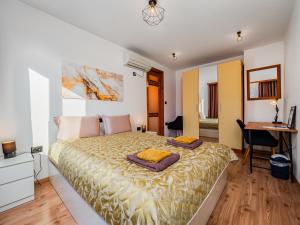 a bedroom with a bed with two pillows on it at Прайм, централен апартамент in Pleven