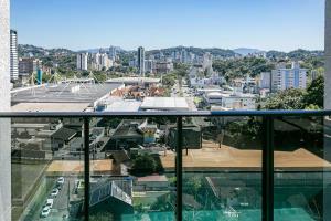 a view of a city from the balcony of a building at Loft Completo com Piscina Aquecida 250m da Vila Germânica in Blumenau