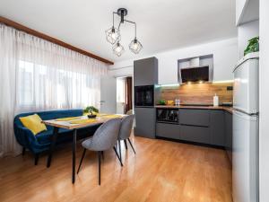 a kitchen and dining room with a table and chairs at Прайм, централен апартамент in Pleven