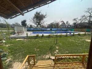a view of a yard with a swimming pool at Bamboo Life in Dera Gopipur