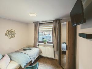 a small bedroom with a bed and a window at STEP IN Apartments ! in Wilhelmshaven