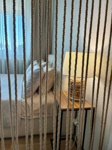 a cage with a bed in a room at Liepų Apartamentai in Molėtai